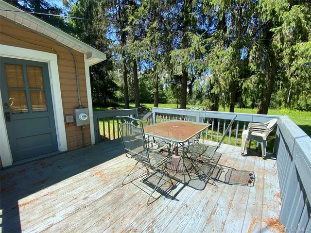 a view of balcony with wooden floor and outdoor seating