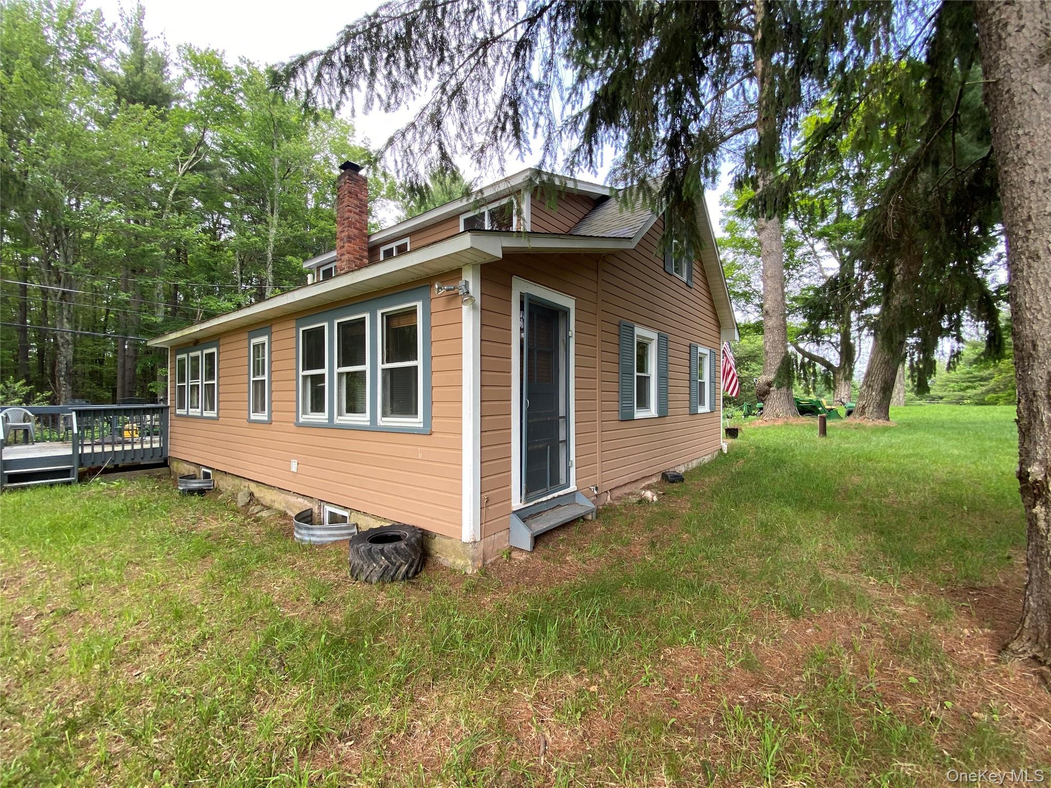 13 Fisher Road Cochecton, NY 12726 - Photo 5 of 32 a house with trees in the background