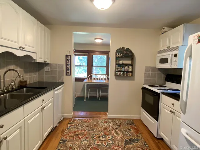 a kitchen with stainless steel appliances granite countertop a refrigerator and a stove