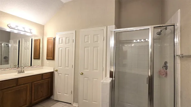 a bathroom with a tub sink shower and mirror