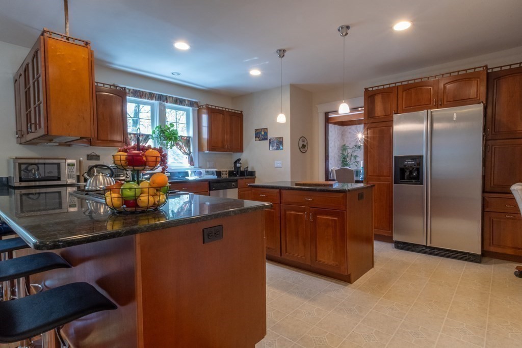182 Marked Tree Road Needham, MA 02492 - Photo 11 of 21 a kitchen with stainless steel appliances granite countertop a sink refrigerator and microwave