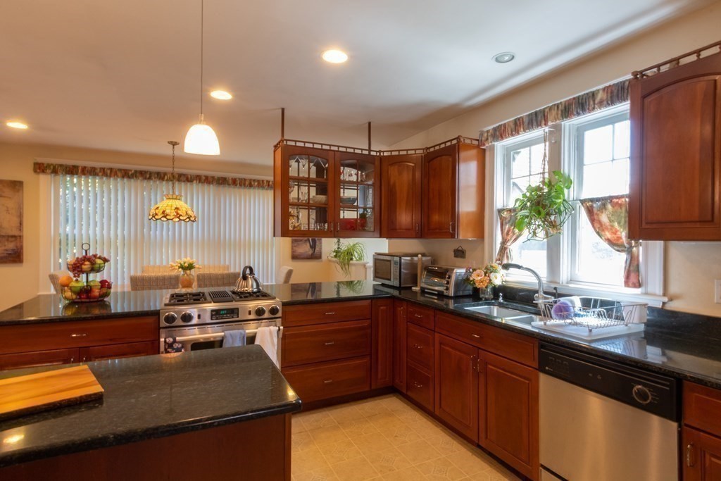 182 Marked Tree Road Needham, MA 02492 - Photo 12 of 21 a kitchen with stainless steel appliances granite countertop a sink stove and cabinets