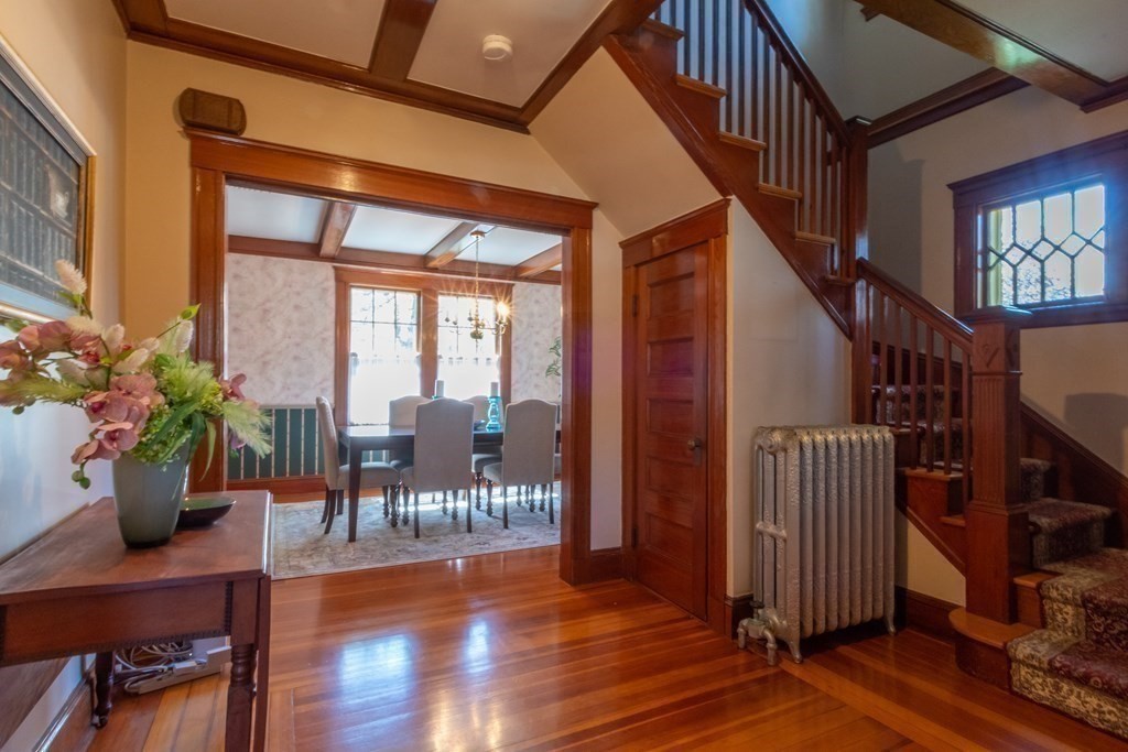 182 Marked Tree Road Needham, MA 02492 - Photo 3 of 21 a hallway with wooden floor stairs and furniture