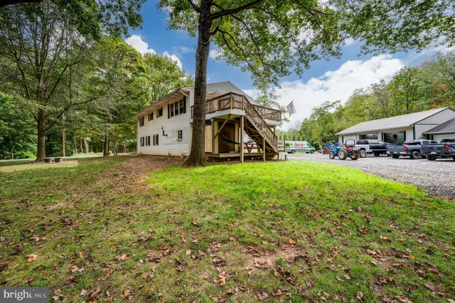 a white house that has a tree in front of it