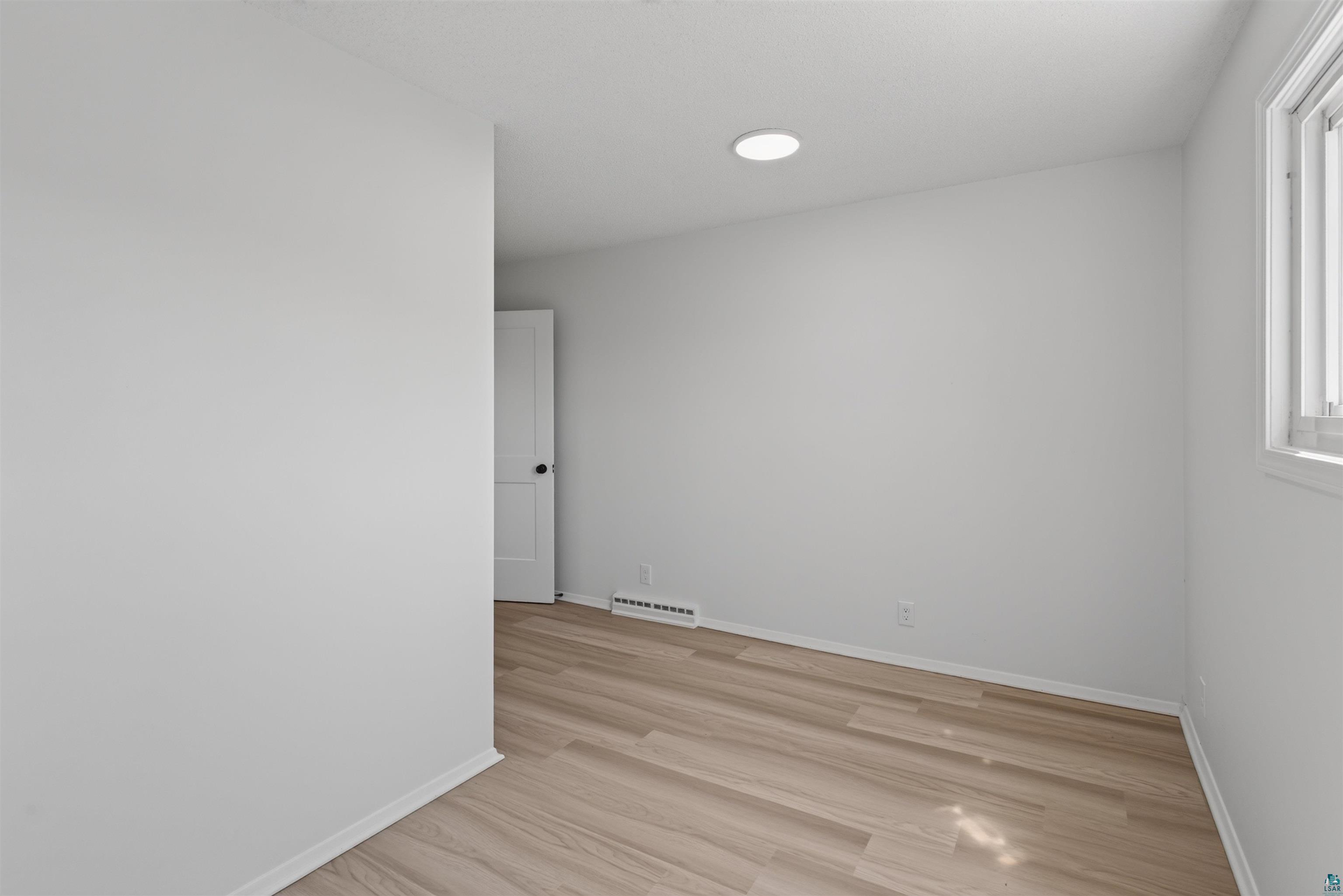 5868 Rice Lake Road Duluth, MN 55803 - Photo 23 of 39 Light wood-finish flooring complements the neutral wall tones