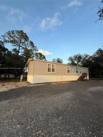 a big house with a big yard and large trees