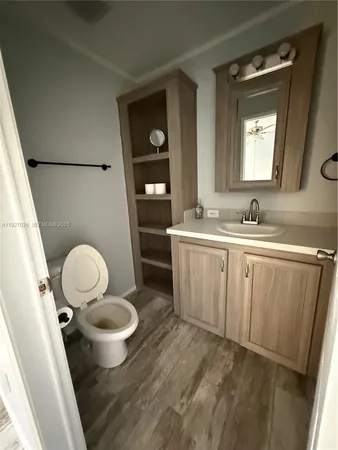 a bathroom with a sink toilet a mirror and vanity