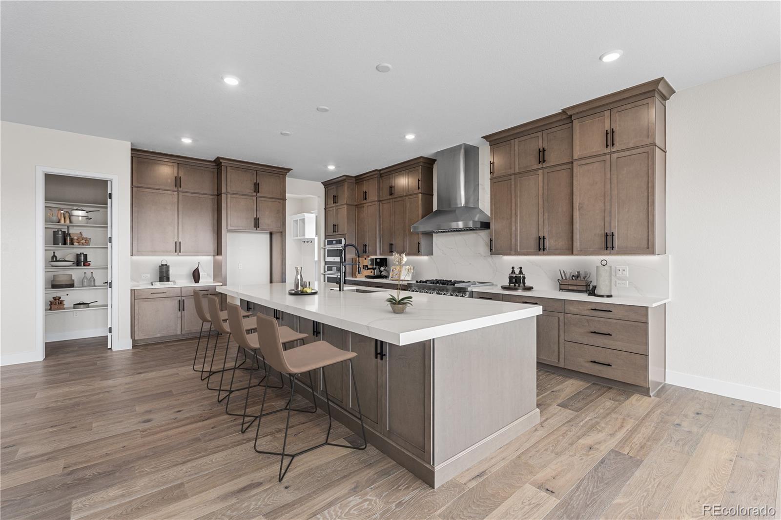 7392 Timberstone Street Castle Pines, CO 80108 - Photo 11 of 42 a kitchen with a sink stove and cabinets