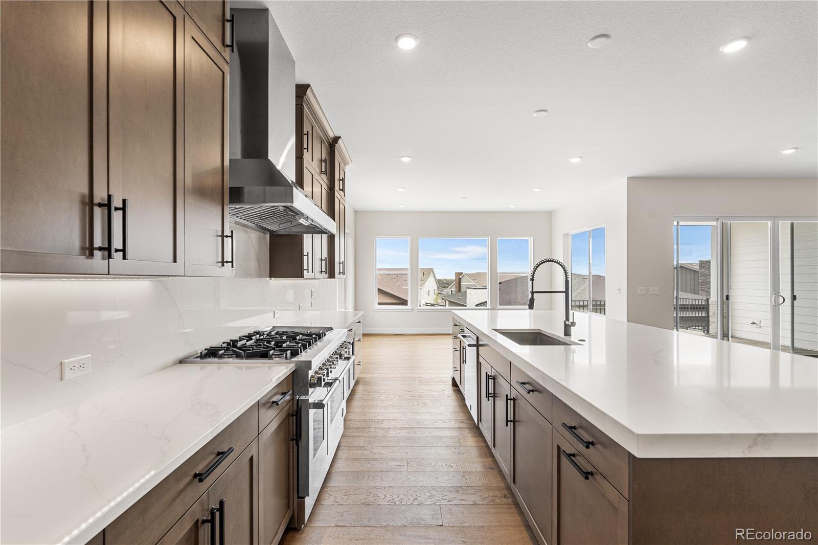 7392 Timberstone Street Castle Pines, CO 80108 - Photo 13 of 42 a large kitchen with stainless steel appliances lots of counter space and a sink