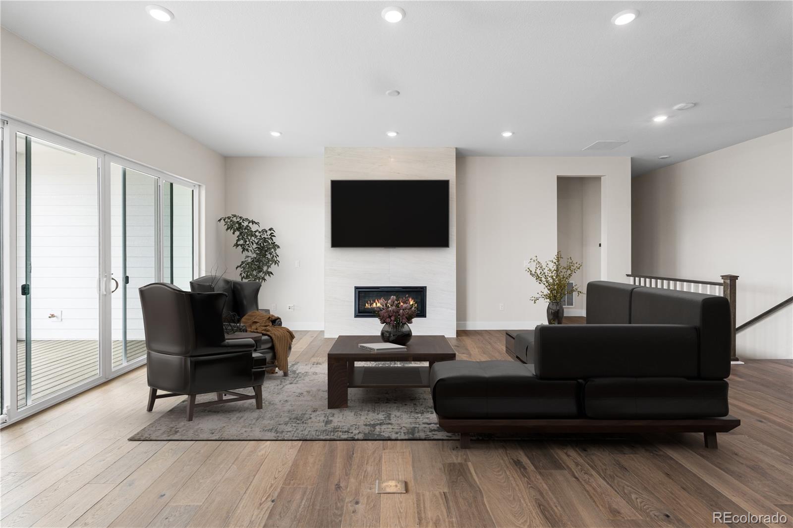 7392 Timberstone Street Castle Pines, CO 80108 - Photo 14 of 42 a living room with furniture and a flat screen tv