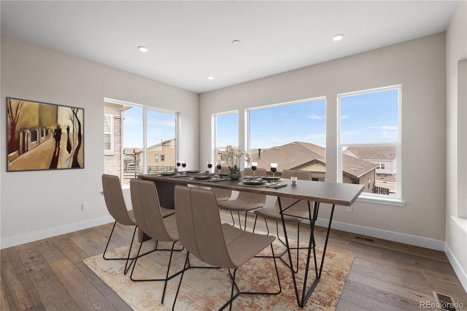 7392 Timberstone Street Castle Pines, CO 80108 - Photo 15 of 42 a view of a dining room with furniture window and wooden floor