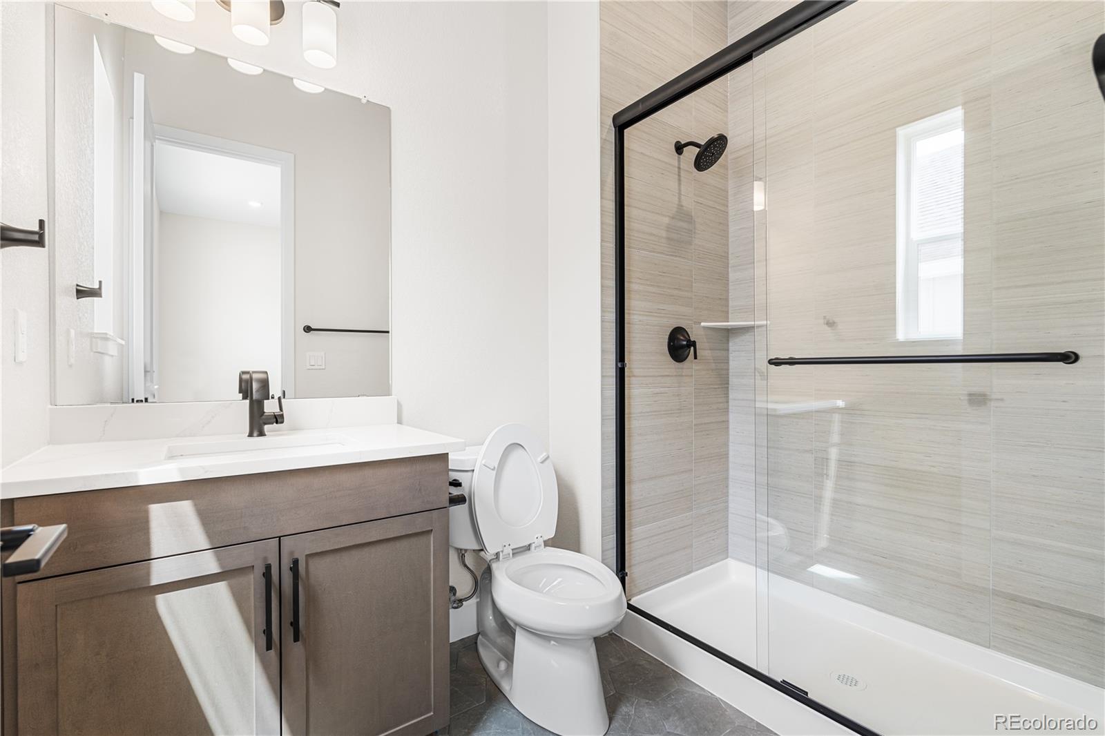 7392 Timberstone Street Castle Pines, CO 80108 - Photo 22 of 42 a bathroom with a sink toilet and shower
