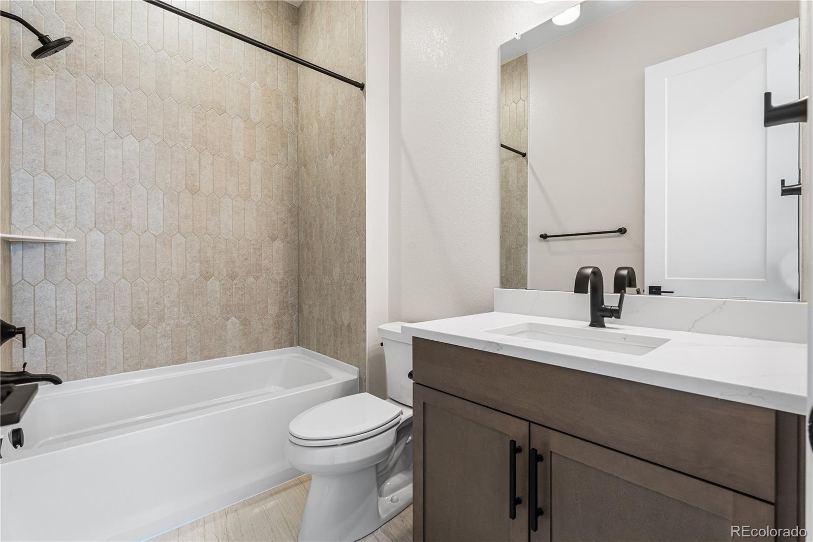 7392 Timberstone Street Castle Pines, CO 80108 - Photo 23 of 42 a bathroom with a sink a toilet and a bathtub