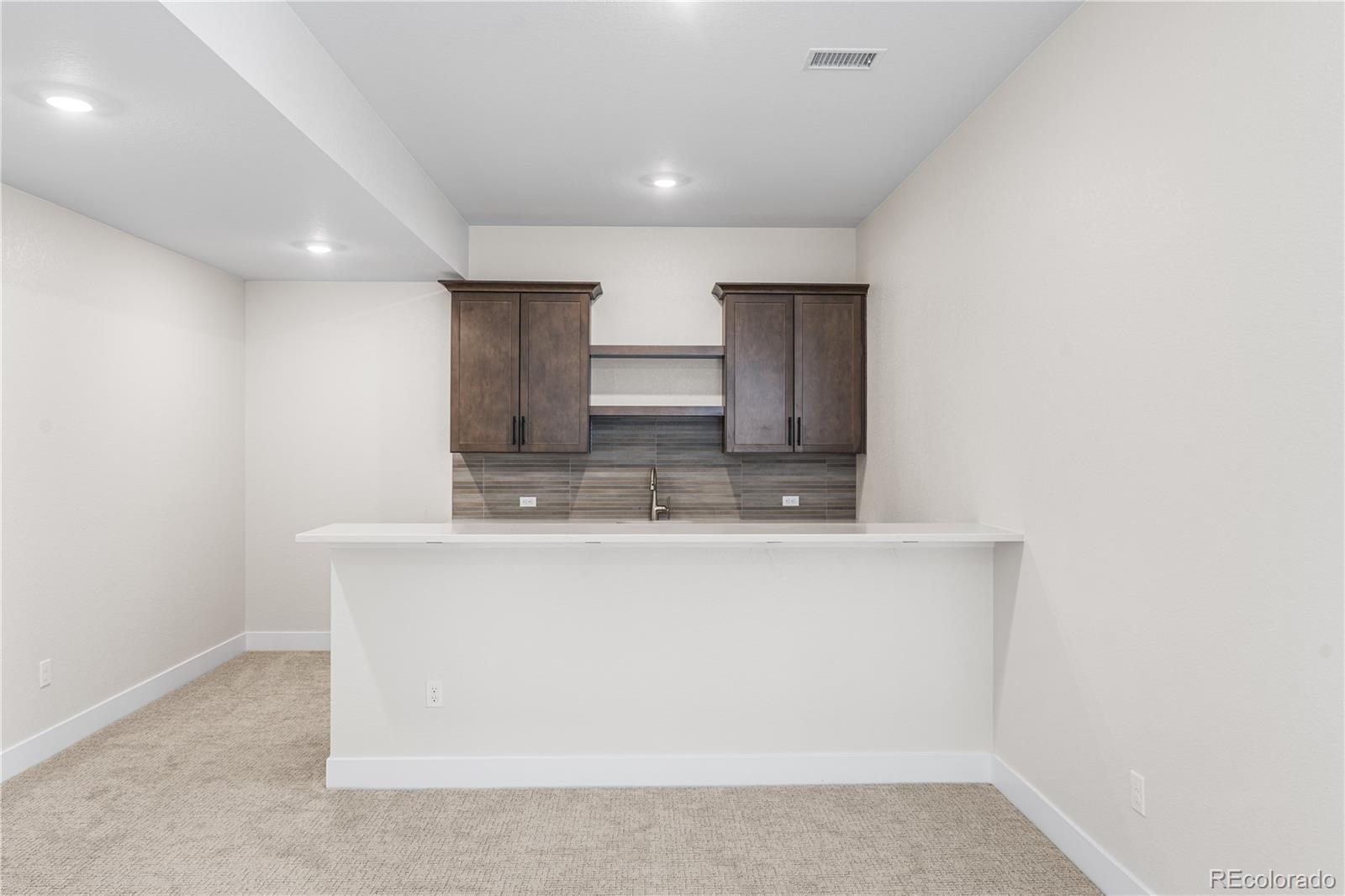 7392 Timberstone Street Castle Pines, CO 80108 - Photo 26 of 42 a view of kitchen island with sink