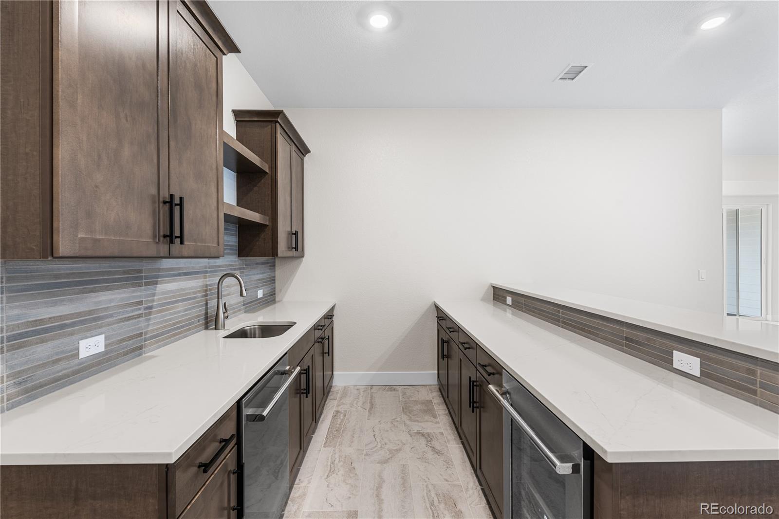 7392 Timberstone Street Castle Pines, CO 80108 - Photo 27 of 42 a kitchen with a sink and a stove top oven
