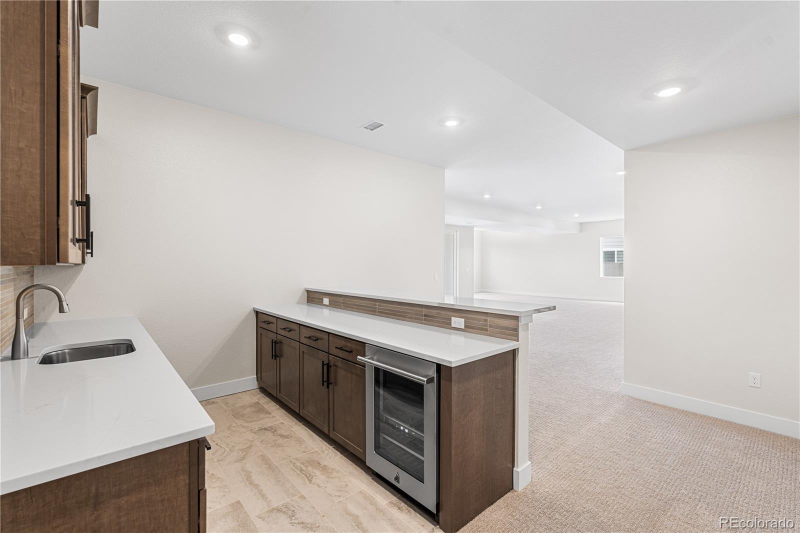 7392 Timberstone Street Castle Pines, CO 80108 - Photo 28 of 42 a kitchen with a stove and a sink