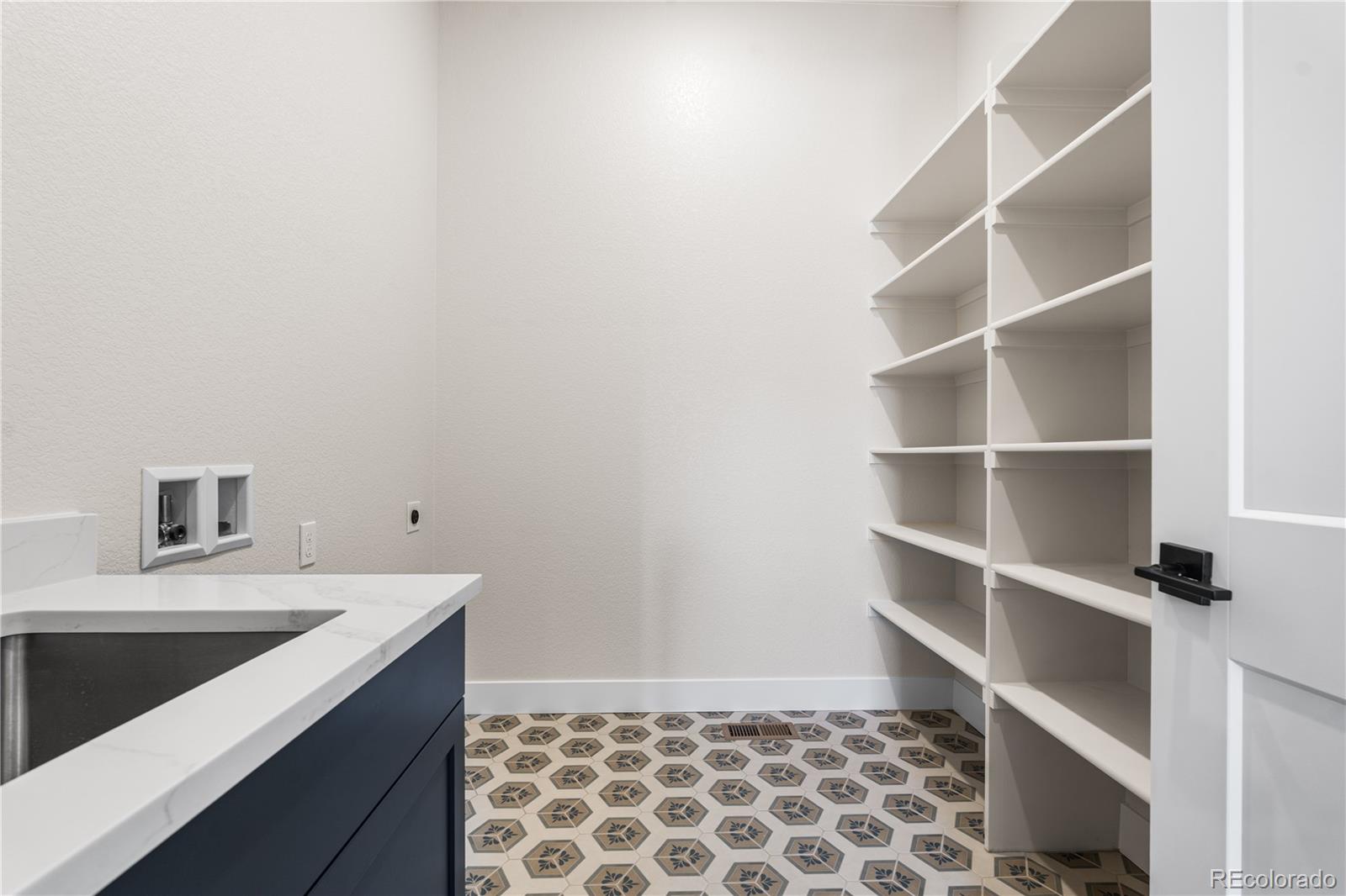 7392 Timberstone Street Castle Pines, CO 80108 - Photo 30 of 42 a view of storage and utility room with a sink