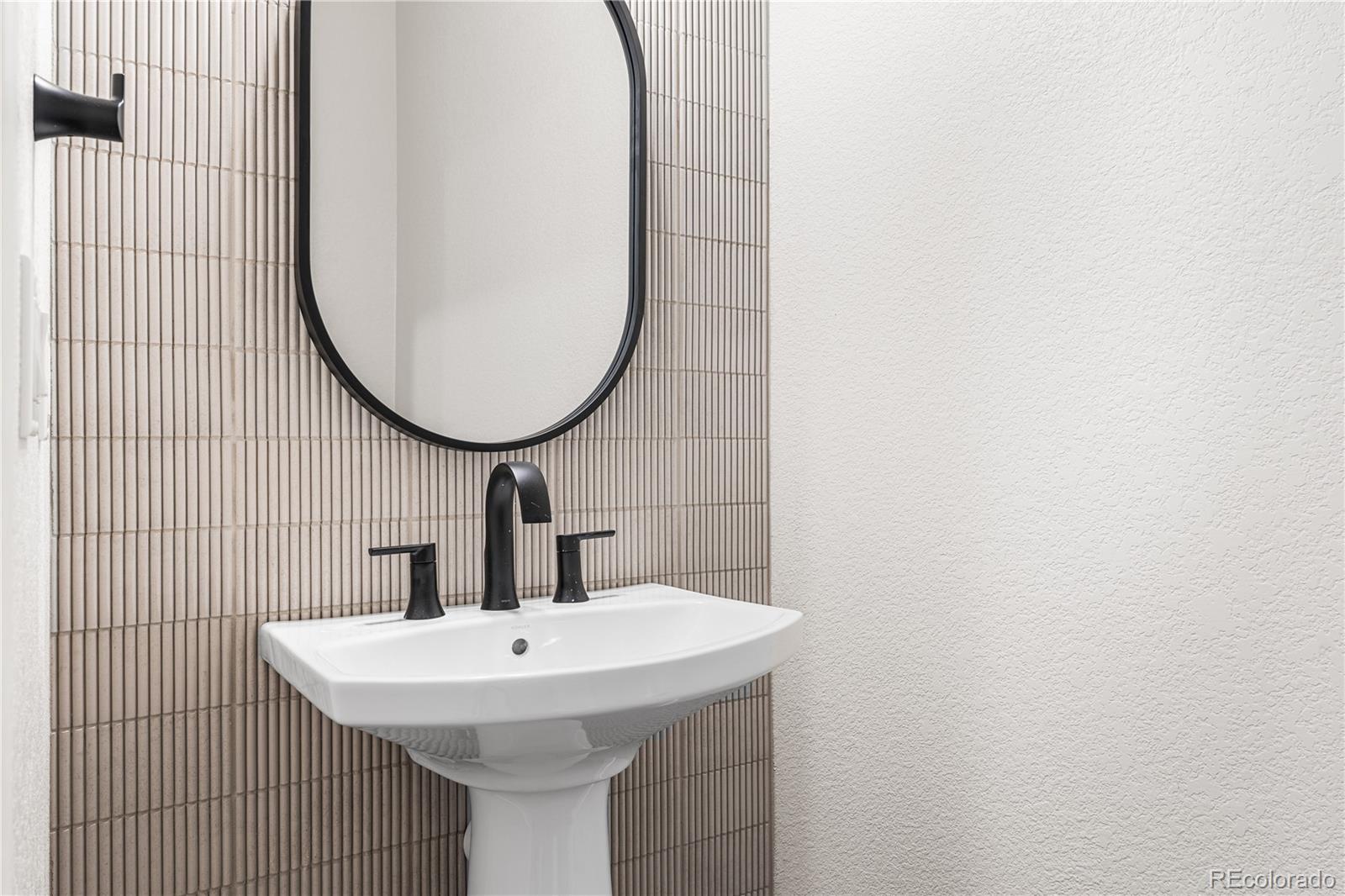 7392 Timberstone Street Castle Pines, CO 80108 - Photo 33 of 42 a bathroom with a sink and a mirror
