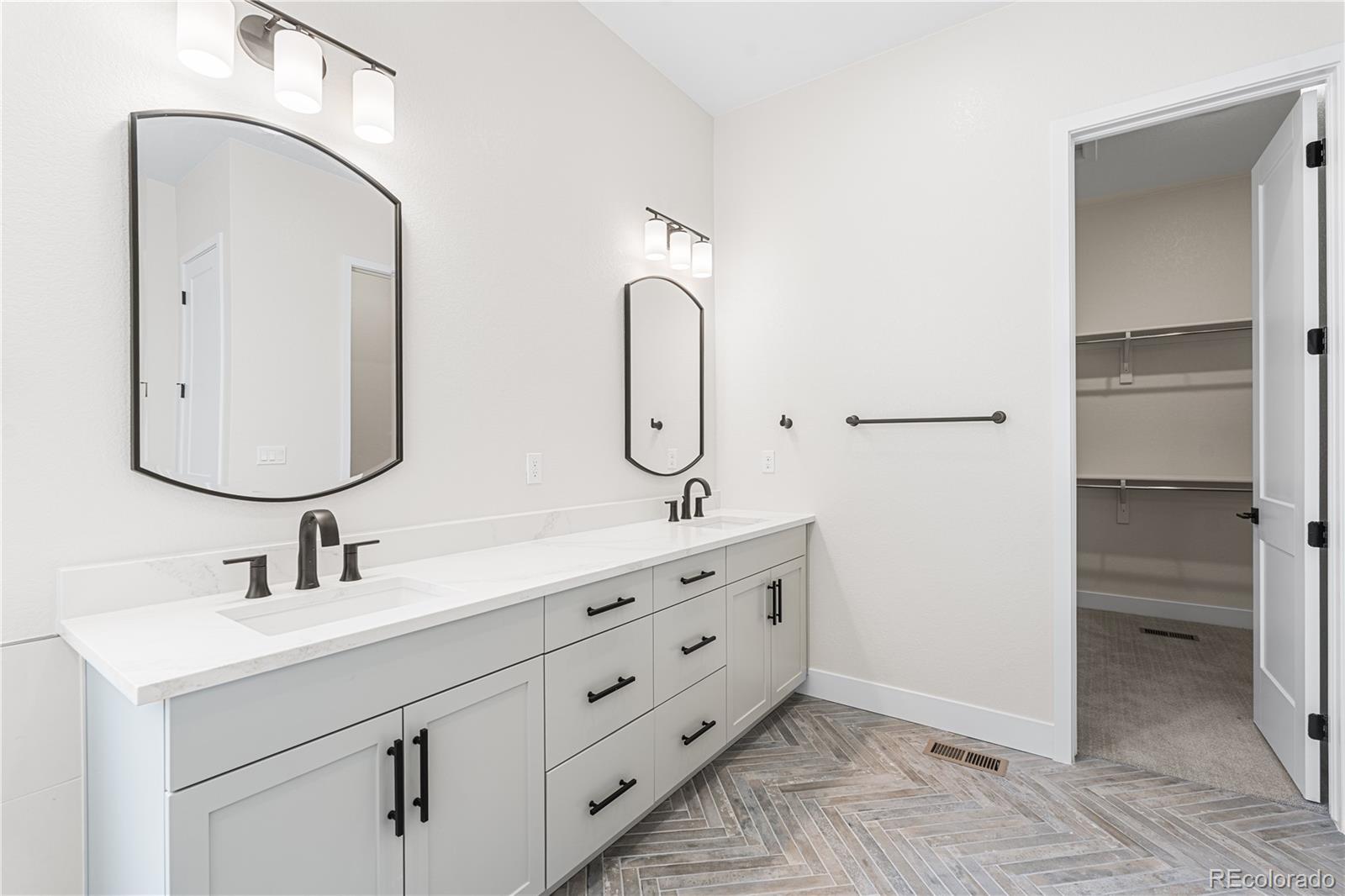 7392 Timberstone Street Castle Pines, CO 80108 - Photo 34 of 42 a bathroom with double vanity sink and a mirror