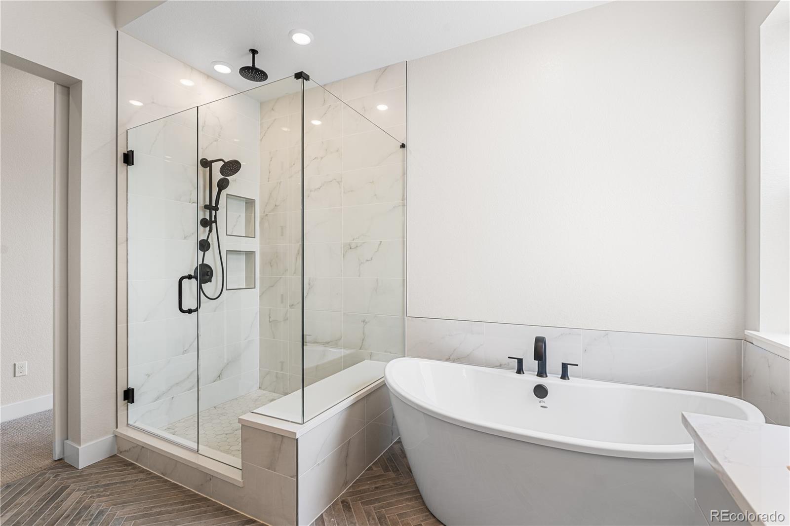 7392 Timberstone Street Castle Pines, CO 80108 - Photo 36 of 42 a bathroom with a bathtub and shower