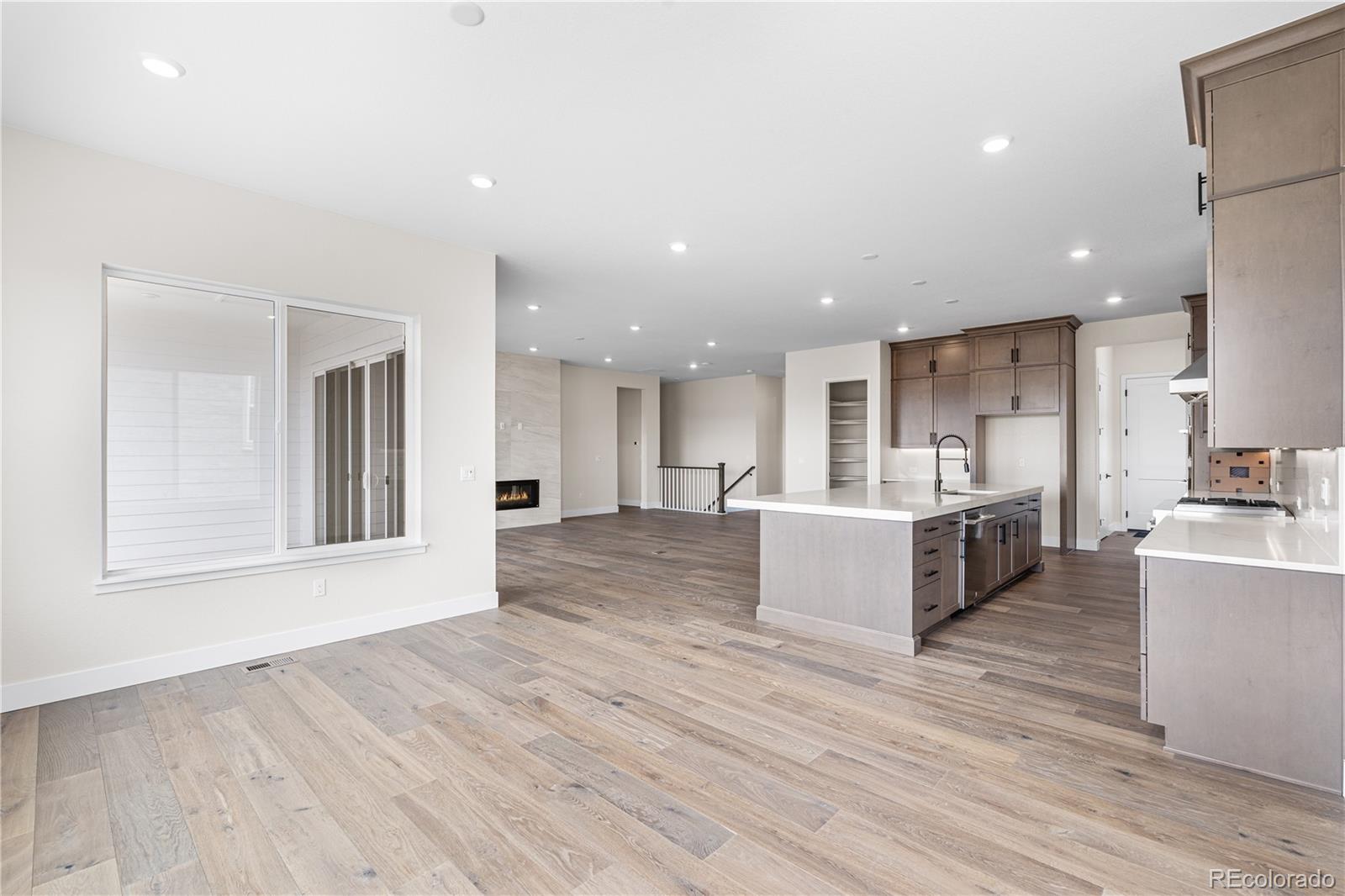 7392 Timberstone Street Castle Pines, CO 80108 - Photo 5 of 42 a view of kitchen with cabinets and wooden floor