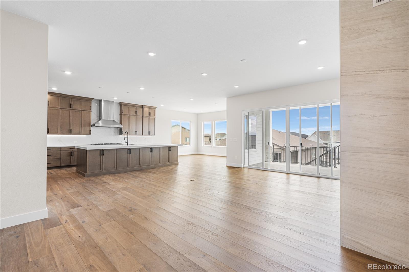 7392 Timberstone Street Castle Pines, CO 80108 - Photo 6 of 42 a view of a kitchen with kitchen island a sink stainless steel appliances and cabinets