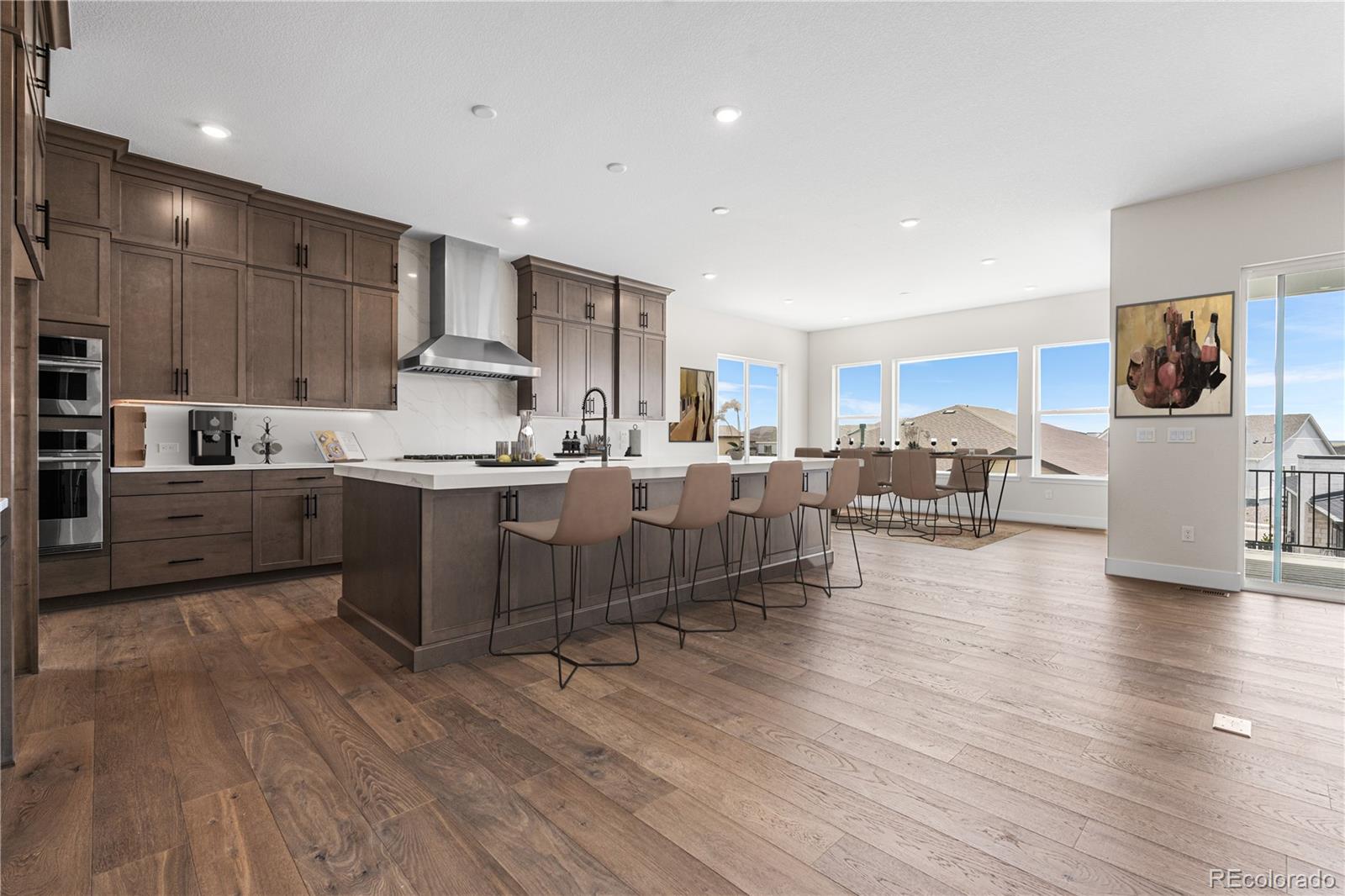 7392 Timberstone Street Castle Pines, CO 80108 - Photo 7 of 42 a kitchen with stainless steel appliances kitchen island granite countertop a sink and cabinets