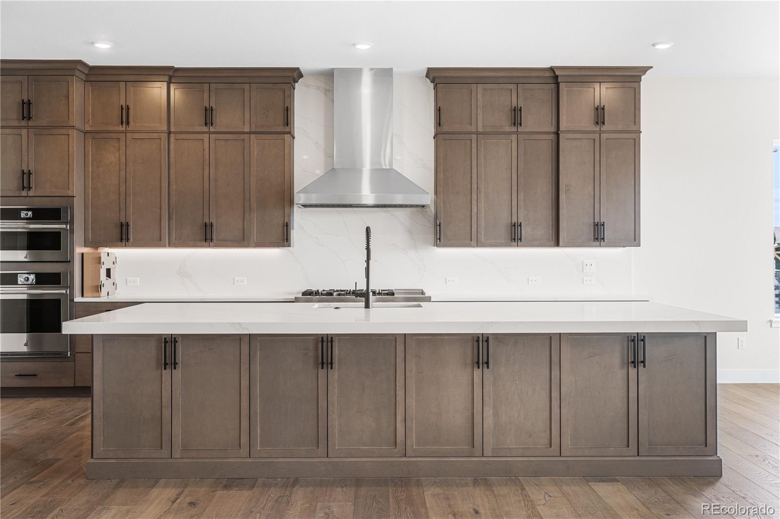 7392 Timberstone Street Castle Pines, CO 80108 - Photo 10 of 42 a kitchen with a sink cabinets and a refrigerator