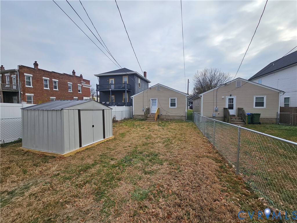 2310 4th Avenue Richmond, VA 23222 - Photo 2 of 9 a spacious bedroom with a large bed and a chandelier