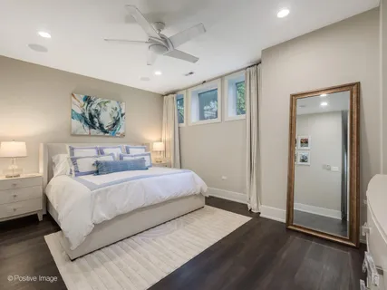 a bedroom with a large bed and a chandelier