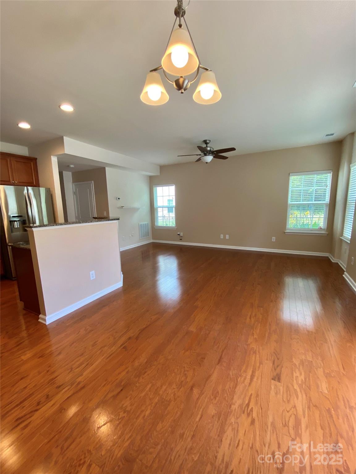 2601 Silverthorn Drive Charlotte, NC 28273 - Photo 11 of 36 an empty room with wooden floor and windows