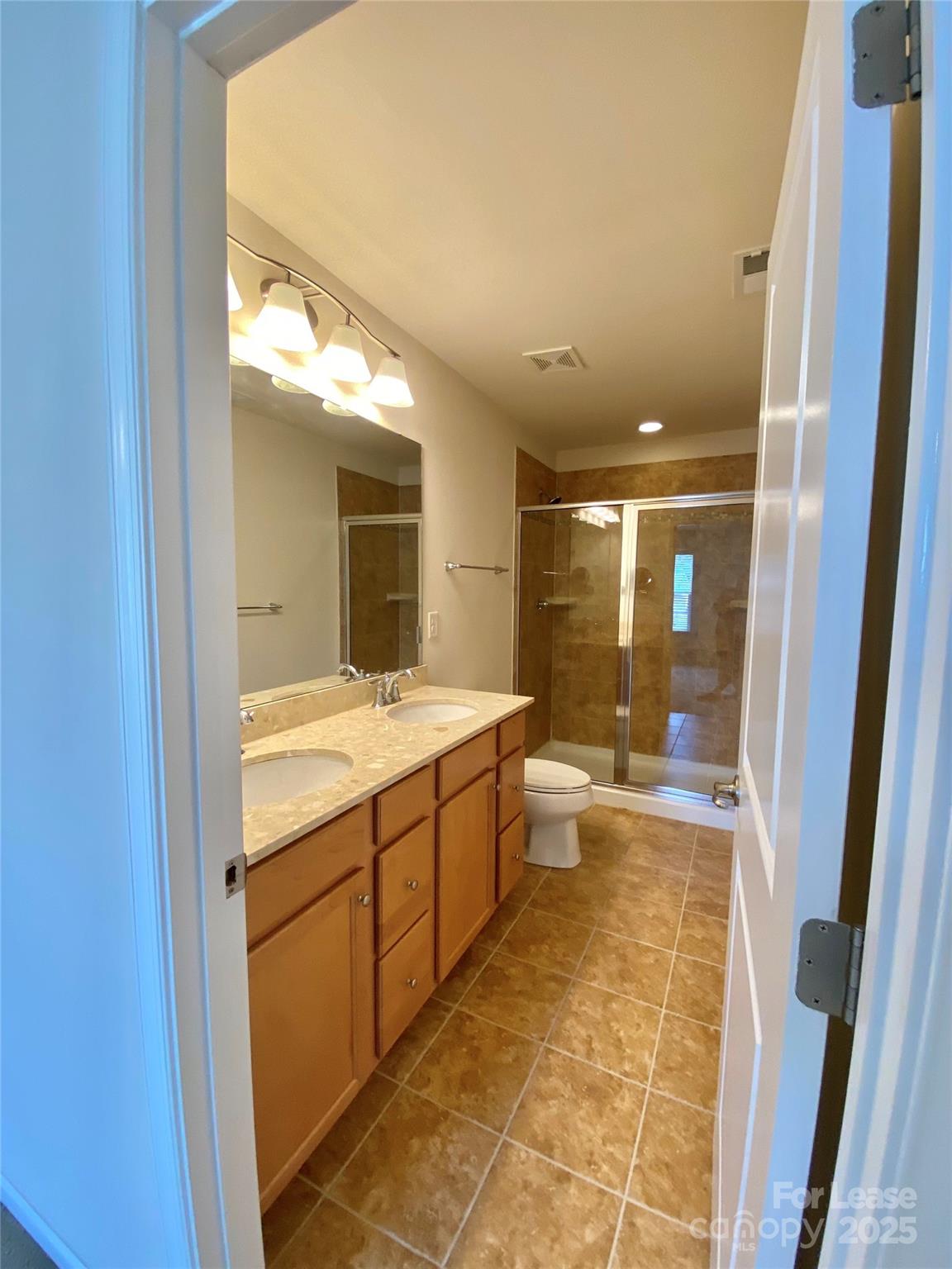 2601 Silverthorn Drive Charlotte, NC 28273 - Photo 22 of 36 a bathroom with a granite countertop sink a mirror and a bathtub