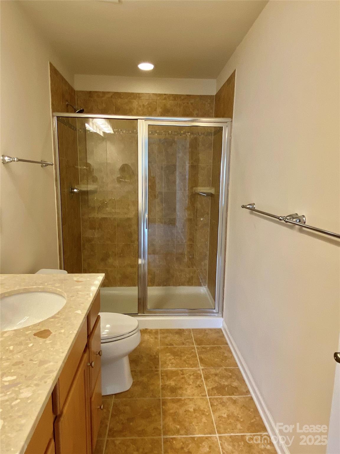 2601 Silverthorn Drive Charlotte, NC 28273 - Photo 24 of 36 a bathroom with a granite countertop sink toilet and shower