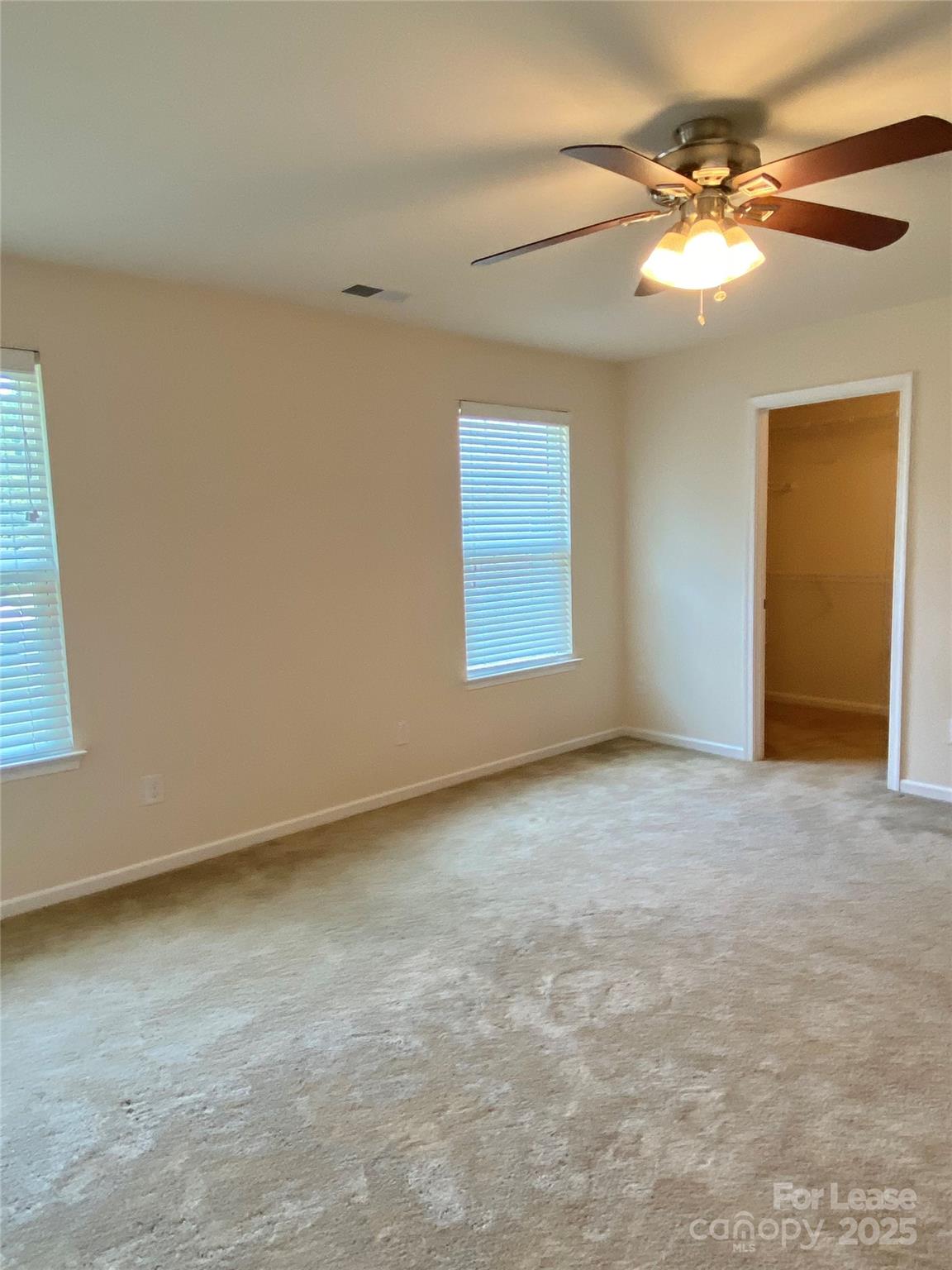 2601 Silverthorn Drive Charlotte, NC 28273 - Photo 27 of 36 an empty room with a chandelier fan and windows