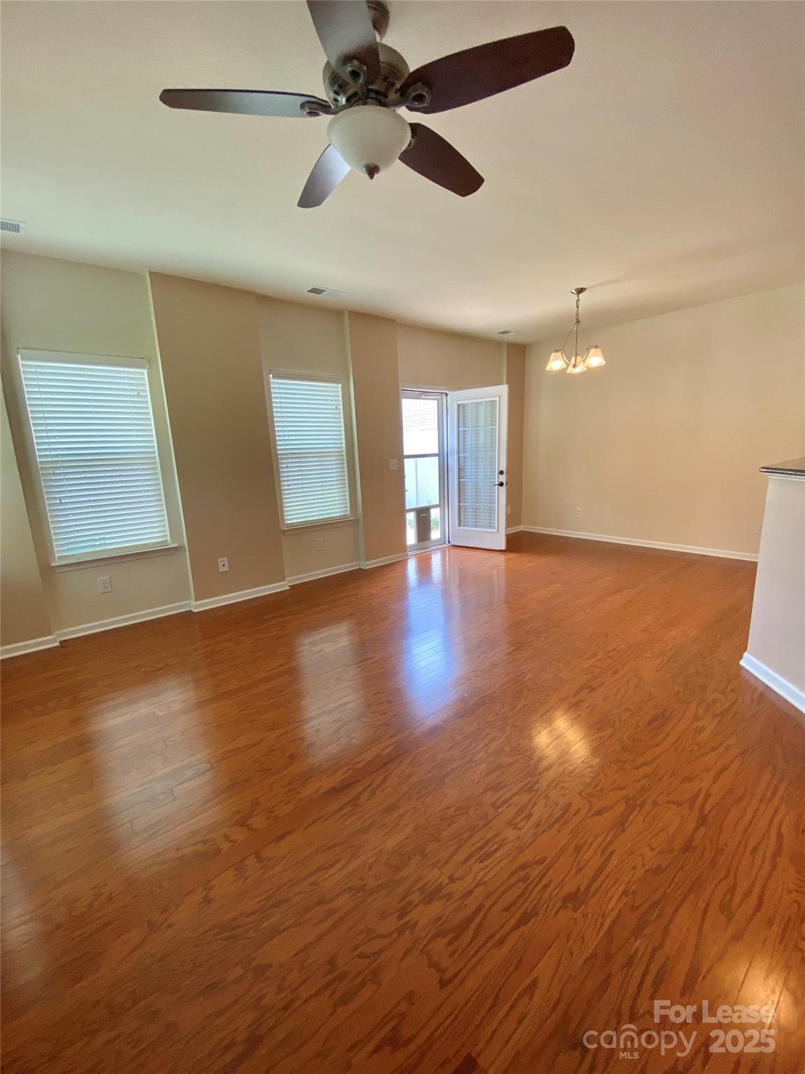 2601 Silverthorn Drive Charlotte, NC 28273 - Photo 9 of 36 a view of an empty room with window and wooden floor