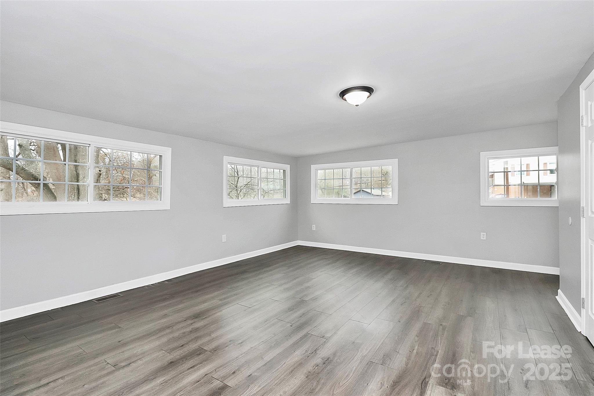 4103 Little Mountain Road Gastonia, NC 28056 - Photo 9 of 20 a view of an empty room with wooden floor and a window