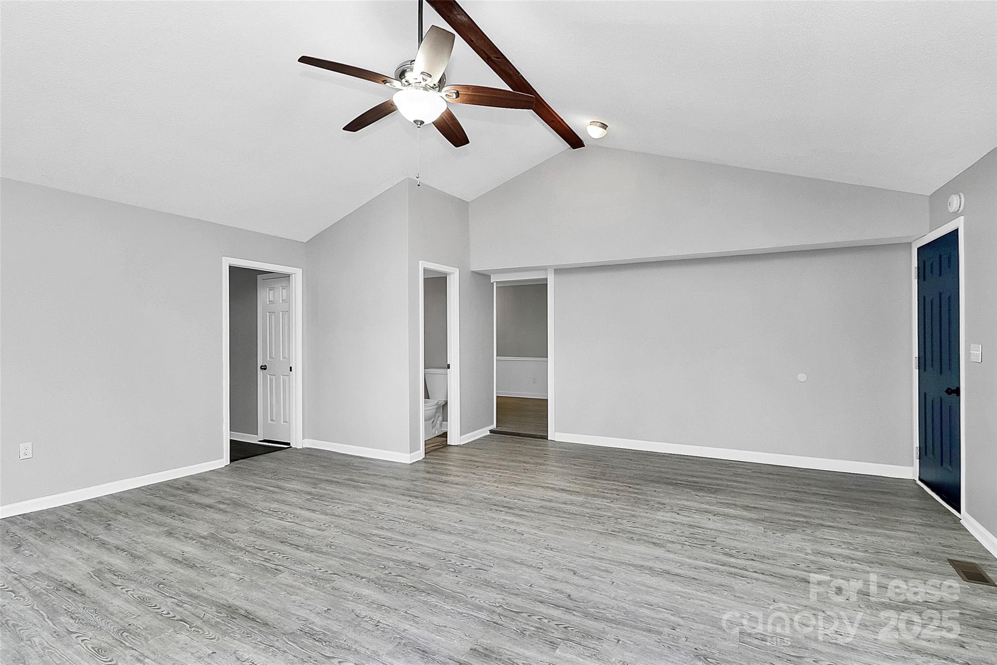 4103 Little Mountain Road Gastonia, NC 28056 - Photo 10 of 20 a view of an empty room with wooden floor and a ceiling fan