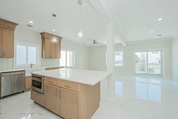 an empty room with a window and a ceiling fan