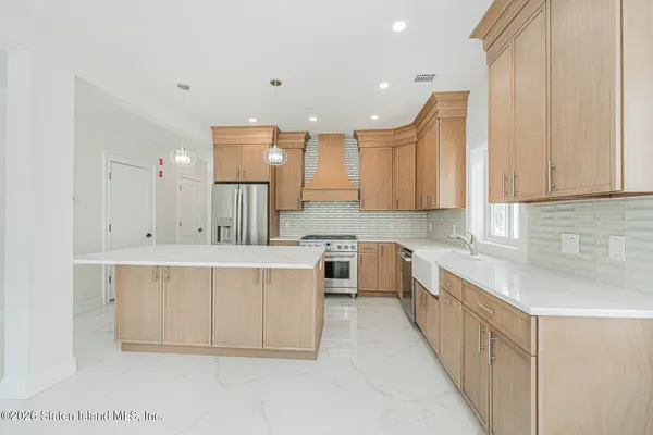 an empty room with a window and a ceiling fan