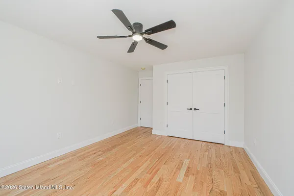 a view of an empty room with glass door and windows