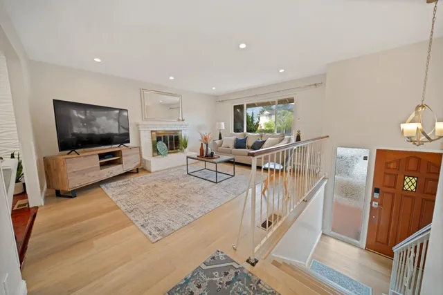 a living room with furniture a flat screen tv and a fireplace