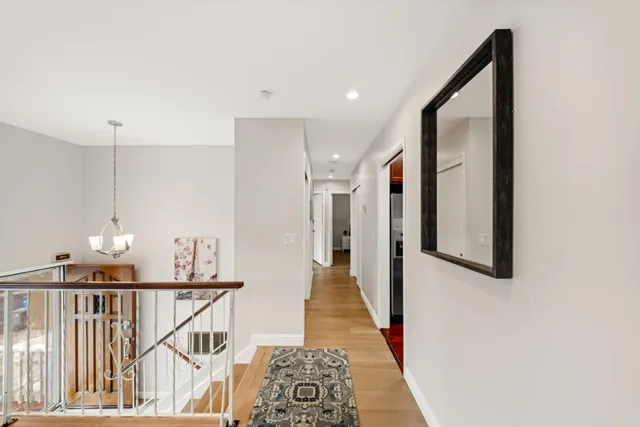 a view of a dining room with furniture wooden floor and chandelier
