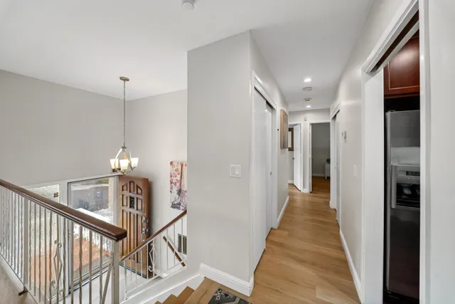 a kitchen with a dining table chairs stainless steel appliances and cabinets