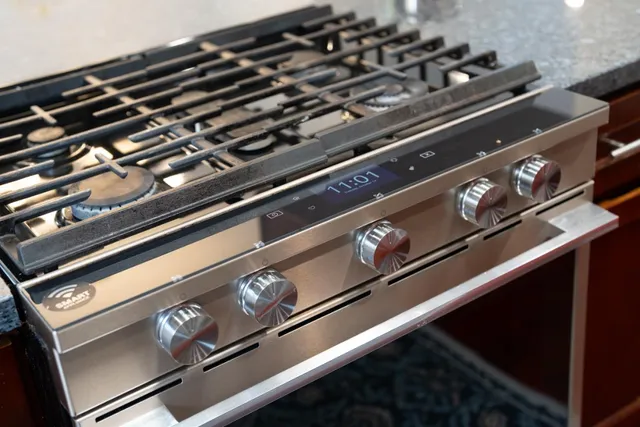 a kitchen stove top oven sitting inside of a kitchen