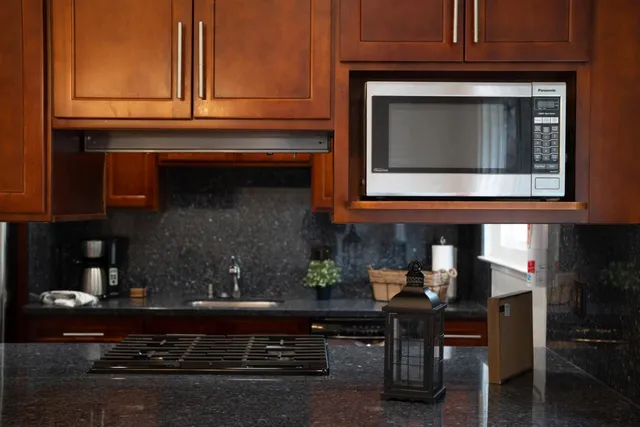 a dining room filled chandelier and wooden floor