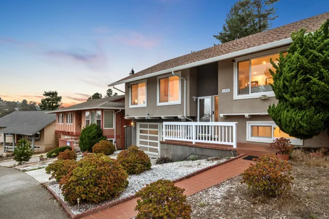 a front view of a house with garden