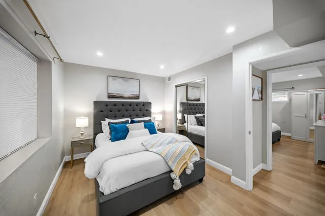 a bedroom with a bed and a window