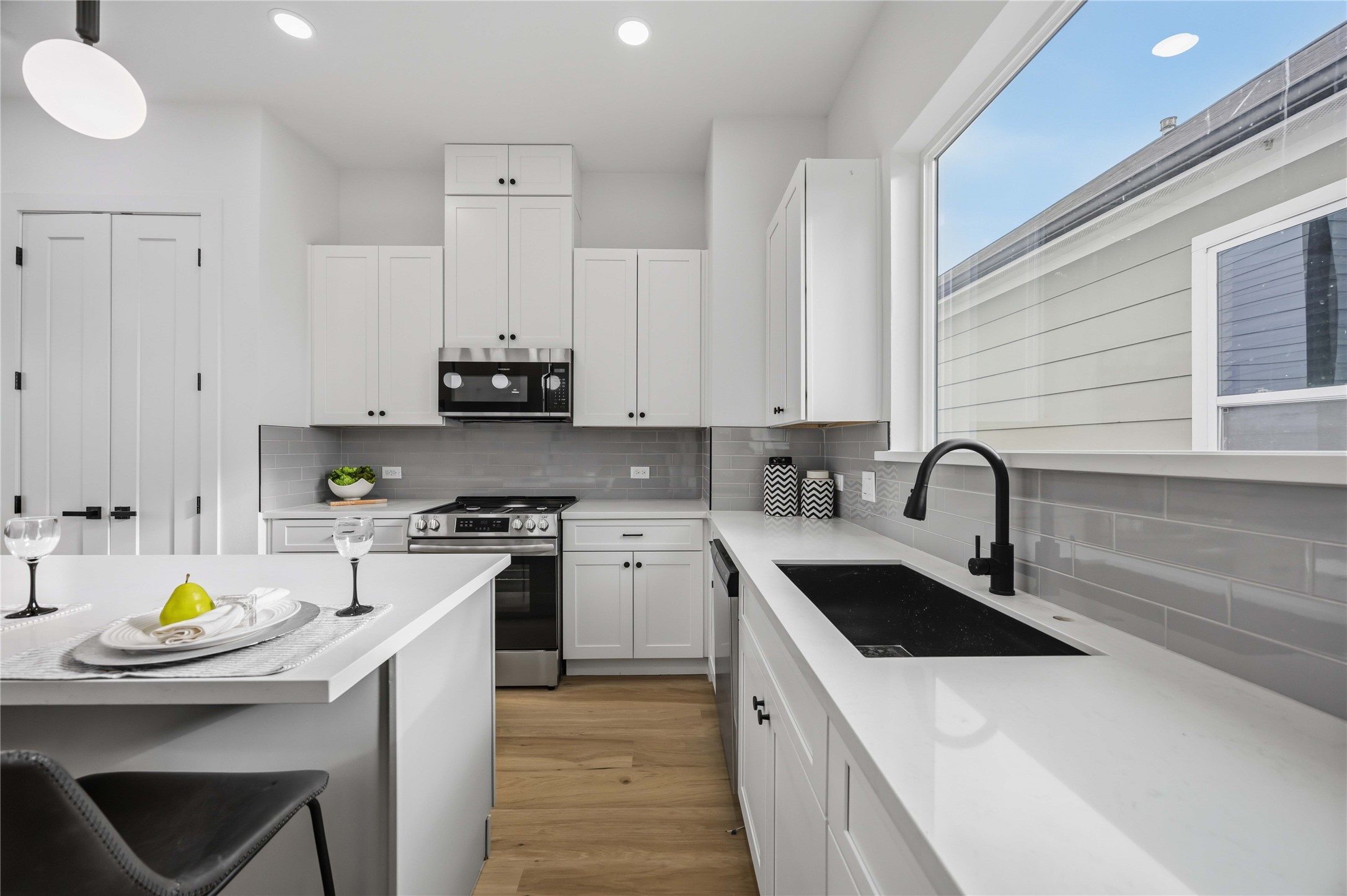 2014 Yates Street Houston, TX 77020 - Photo 13 of 45 a kitchen with kitchen island granite countertop a sink a stove cabinets counter top space and stainless steel appliances