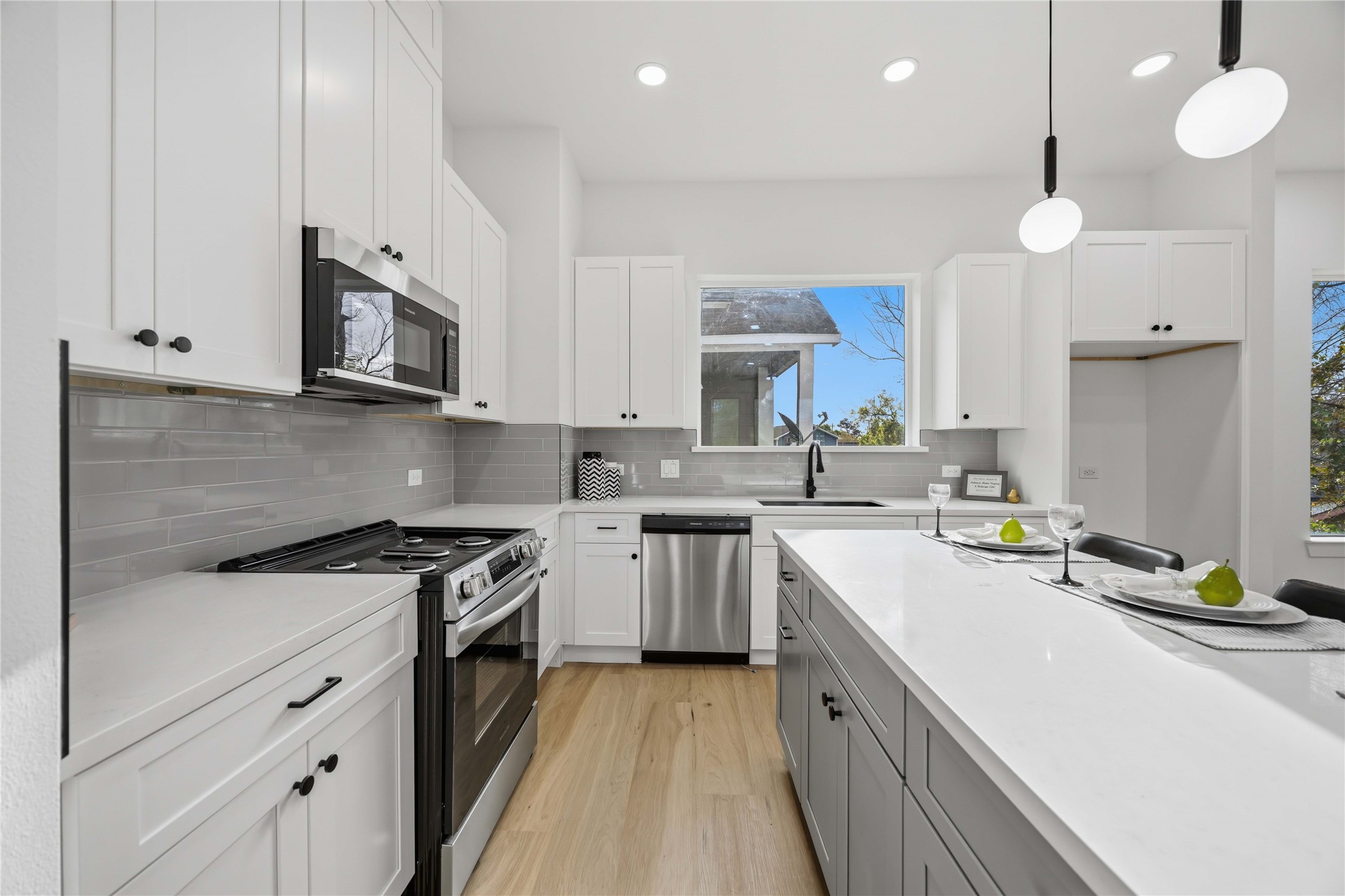 2014 Yates Street Houston, TX 77020 - Photo 14 of 45 a kitchen with stainless steel appliances white cabinets sink and stove