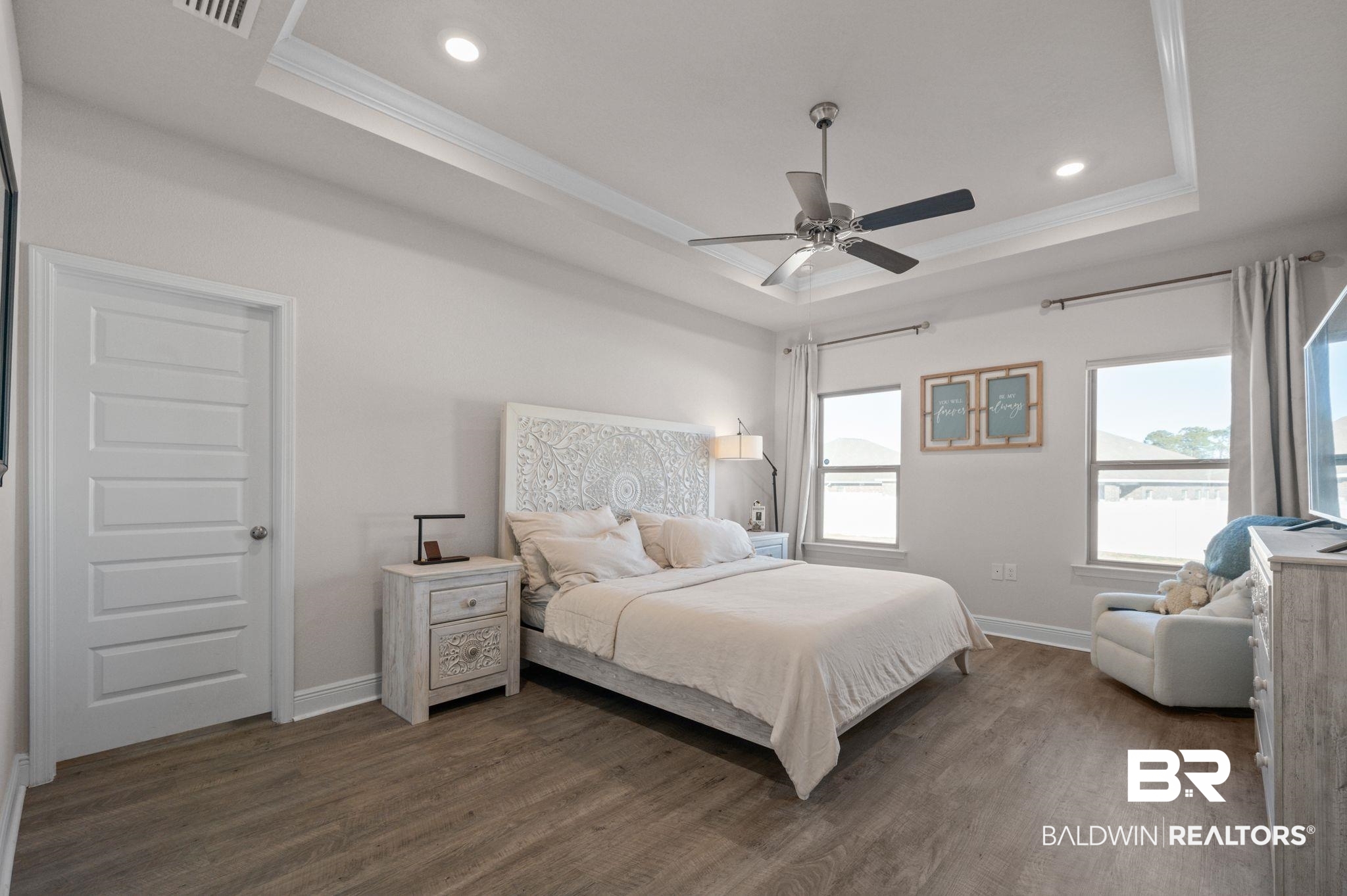 24891 Spectacular Bid Loop Daphne, AL 36526 - Photo 48 of 51 Bedroom featuring ceiling fan, ornamental molding, a tray ceiling, and dark hardwood / wood-style flooring